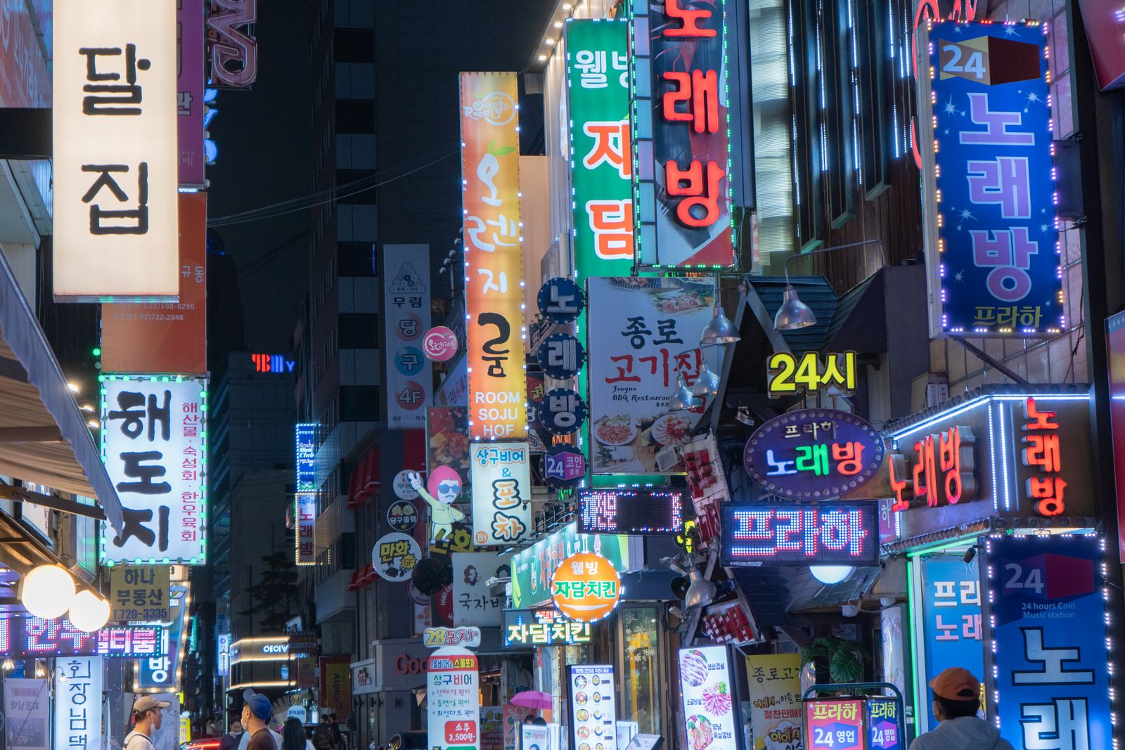 Neon-lit Myeongdong shopping street at night